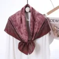 Detailed view of the elegant velvet square scarf showcasing double-sided paisley print texture. - Style 14