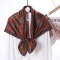 Detail view of the elegant printed velvet square scarf, featuring a rich brown paisley design. - Style 36