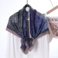 Detailed view of dark blue and purple printed silk scarf, elegant floral paisley design. - Style 20