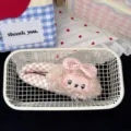 Close-up detail of cute fluffy sheep hair clip featuring a pink gingham bow accessory. - Pink Bow Hair Clip
