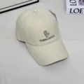 Detail shot of a stylish beige baseball cap featuring fine front embroidery and a curved brim. - L (58-60cm) / Beige