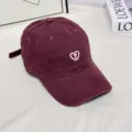 Detailed view of the vintage corduroy baseball cap featuring a pearl heart embroidery. - M (56-58cm) / Wine Red