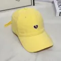 Detail view of yellow cotton baseball cap with cute heart embroidery and adjustable strap. - M (56-58cm) / Banana Yellow