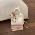 Korean style PU leather bucket bag with cute bear pendant and stylish crossbody shoulder strap. - With Charm / White