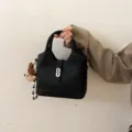 Black bucket bag for women, stylish top handle shoulder bag with lock charm for daily commute. - With Charm / Black