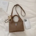 Stylish brown PU leather bucket bag with top handle, shoulder strap and cute bear charm. - With Charm / Brown