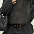 Close-up of a dark brown braided leather belt with small gold buckle worn with textured knit. - 110cm / Coffee