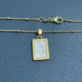 Detail shot of a gold plated 925 silver square mother of pearl sacred heart pendant necklace. - Gold