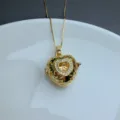 Close-up view of a chic gold-plated heart pendant necklace featuring delicate sparkling stones. - Style B