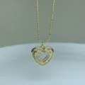 Gold-plated double heart pendant necklace detail, sparkling cubic zirconia stone accents. - White