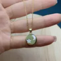 Detailed view of the gold-plated star and moon pendant necklace with white mother-of-pearl. - Pentagram / Gold