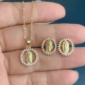 Gold-plated religious portrait jewelry set featuring matching necklace and earrings with clear stones. - White