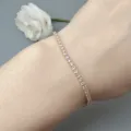 Delicate pink cubic zirconia tennis bracelet detail shot, elegant gold tone wrist jewelry. - Gold-White