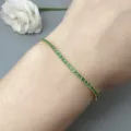 Delicate gold plated tennis bracelet featuring sparkling green cubic zirconia for women. - Gold-Green