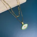 Double layer evil eye pendant necklace featuring white mother of pearl and green stone pave. - Green