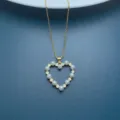 detail view of gold chain necklace with faux pearl rhinestone heart pendant elegant fashion - Pearl A