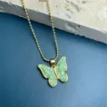 Green mosaic butterfly pendant necklace detail view, elegant gold ball chain accessory. - Green