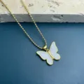 Gold beaded chain necklace featuring a white shell butterfly pendant, elegant stylish jewelry. - White