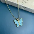 Gold-tone beaded chain necklace featuring a stunning blue shell mosaic butterfly pendant for women. - Blue