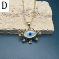 Close-up of the elegant evil eye pendant necklace with mother-of-pearl and crystal details. - Style D