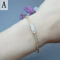Gold open cuff bracelet with sparkling cubic zirconia stones, elegant wrist jewelry detail view. - Style A