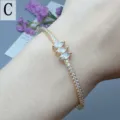 Elegant gold-tone open cuff bracelet featuring marquise zirconia stones for women. - Style C