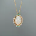 Gold-plated necklace featuring an oval mother-of-pearl Virgin Mary pendant with clear cubic zirconia. - Style C