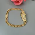 Gold cuban link bracelet featuring a rhinestone paved religious figure pendant for women. - White