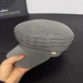 Detailed view of the stylish grey knitted newsboy cap featuring a chic metallic side accent. - M (56-58cm) / Dark Gray