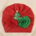 Close-up detail of the red baby turban hat featuring a sparkling Christmas tree and fabric flowers. - One Size / Red with Christmas Tree