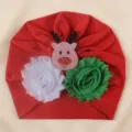 Detailed view of the Christmas baby turban hat featuring reindeer and flower decor. - One Size / Red with Fabric Reindeer