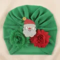 Green baby turban hat with Santa Claus motif and floral decorations for holiday festive wear - One Size / Green with Santa Claus