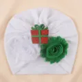 White baby turban hat featuring a sparkling Christmas gift box and cute double fabric flowers. - One Size / White with Gift Box