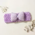 Close-up detail of the purple knitted baby headband featuring a cute plaid bow, soft. - Purple