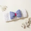 Close-up of cute baby hairband with blue checkered bow on white crochet elastic band. - White