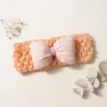 Detailed view of the cute baby crochet headband with a soft checkered bow for infants. - Xueya