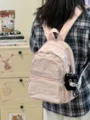 Detailed view of the cute pink mini backpack showing fabric texture and cute pendant charm. - With Charm / Pink
