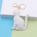 White PU leather cat keychain detail view, cute bag charm with gold metal hardware. - Cat / White - Gold Chain Buckle