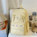 Zaino in tela gialla carino con dettagli a fiocco e tasca frontale per uso scolastico. - Giallo (Senza Ciondolo)