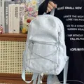 Detailed view of light blue polka dot backpack with front zipper pocket and drawstring style. - Moon Pendant / S / Blue