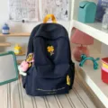 Casual dark blue backpack with yellow clover embroidery and cute plush pendant for daily use. - With Charm / S / Dark Blue
