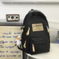 Black utility backpack with multi-compartments, beige pull tabs and cute duck pendant. - Black Leg Duck Pendant / L / Black