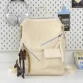 Beige motorcycle style backpack with cute charms, casual commuter bookbag for daily use. - Chocolate Dog Pendant / Off White