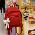 Red mini backpack for women, stylish minimalist casual small daypack with bow pendant. - With Charm / Red
