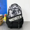 Camo utility backpack in black grey with white print and cute dino pendant for school use - Black and White Camouflage with Dinosaur