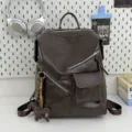 Retro dark brown leather backpack with stylish zippers and cute charm for daily commute. - Chocolate Dog Pendant / Brown