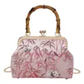 Close-up detail of the retro pink kiss-lock bag featuring delicate bamboo and cute panda patterns. - Pink Bamboo Handle