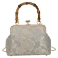 Vintage floral brocade handbag detail featuring a unique bamboo handle and gold frame. - Bamboo Handle / Blue