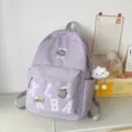 Light purple aesthetic school backpack with varsity letters and cute pendant for daily travel use. - Long-Legged Cloud Pendant / Purple