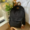 Black casual school backpack for teenage girls, daily daypack with front pocket and charm. - Hat Elf Pendant / Black
